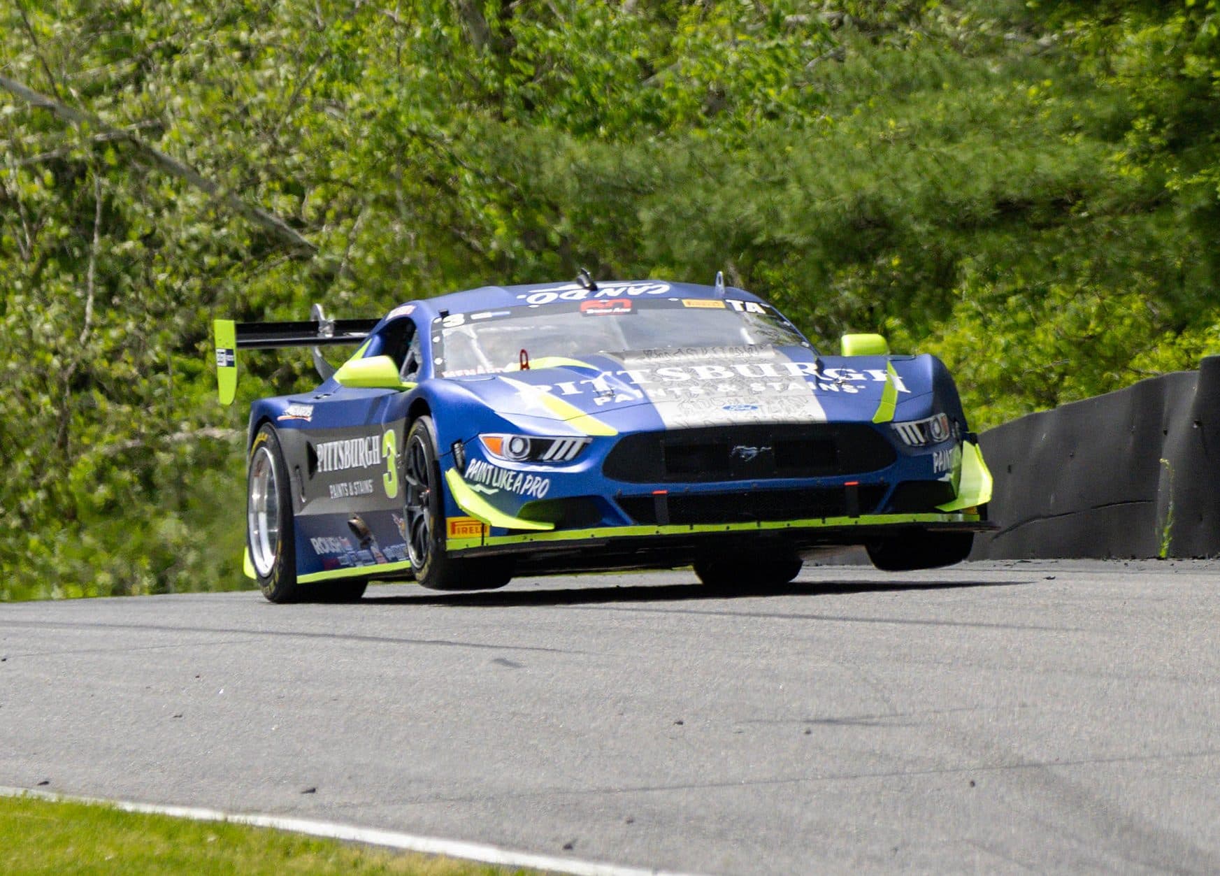 The No. 3 Pittsburgh Paints Mustang gets full commitment through Lime Rock's uphill esses, all four tires loaded and the rear end stepping out.